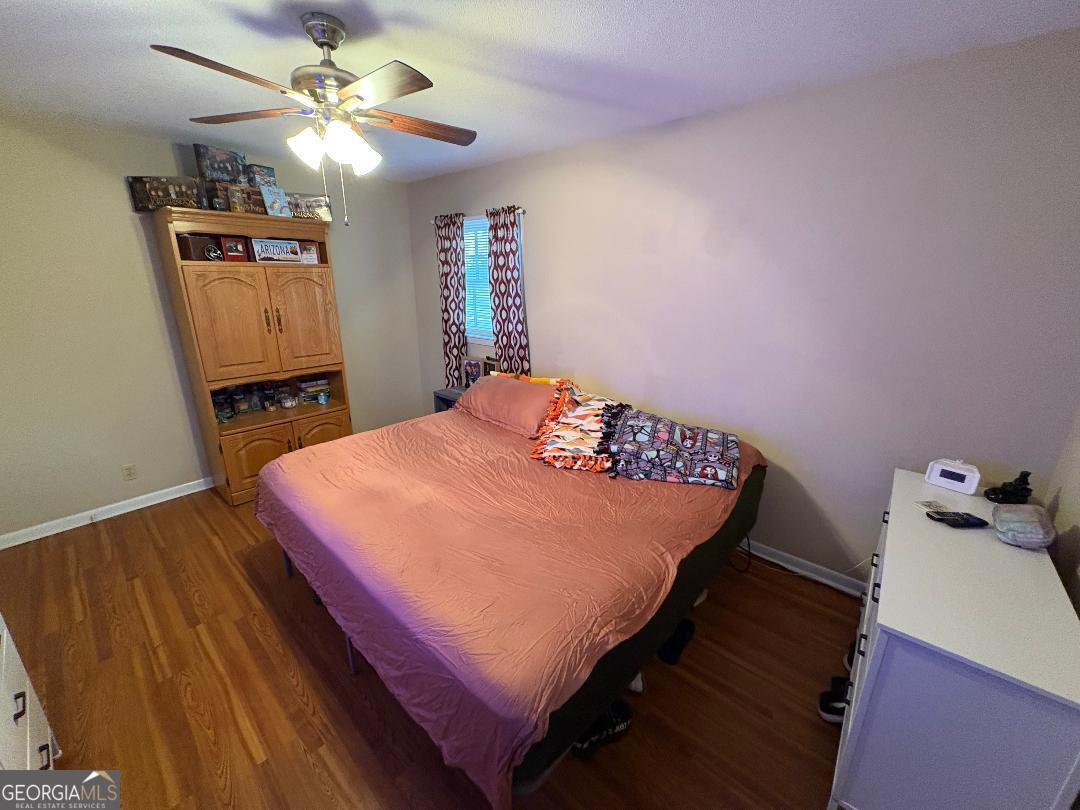 2103 Aimwell Road Vidalia, GA 30474 - Photo 18 of 22 a bedroom with a bed and a chandelier