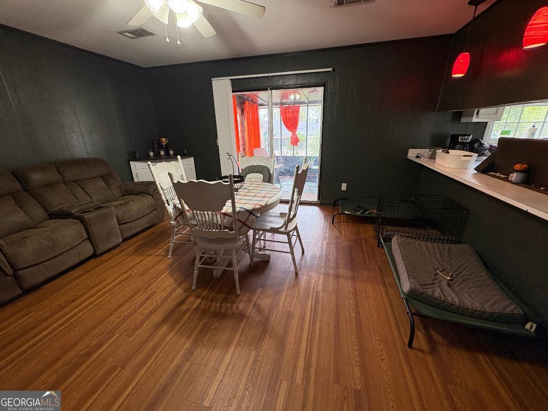 2103 Aimwell Road Vidalia, GA 30474 - Photo 3 of 22 a dining room with furniture a chandelier and wooden floor