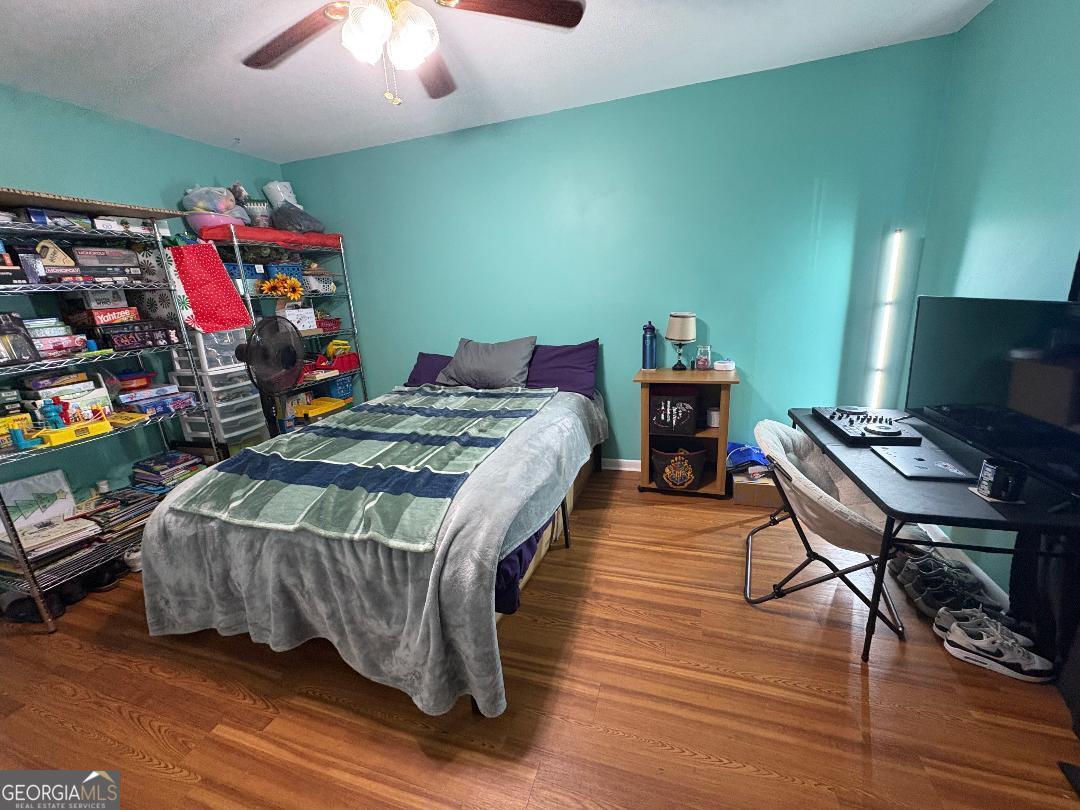 2103 Aimwell Road Vidalia, GA 30474 - Photo 7 of 22 a bedroom with a bed table and a chandelier