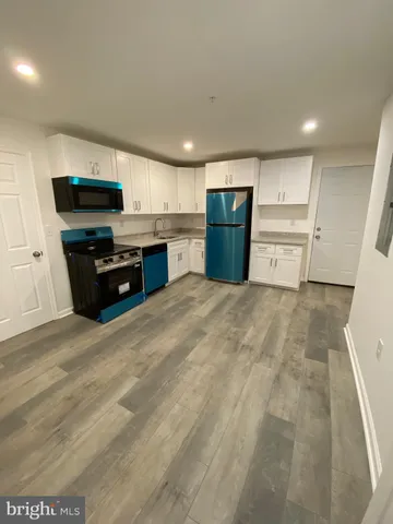 a large kitchen with stainless steel appliances granite countertop a large counter top and a stove top oven