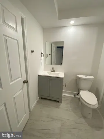 a bathroom with a toilet a sink and bathtub