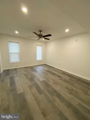 a view of a livingroom with a ceiling fan and window