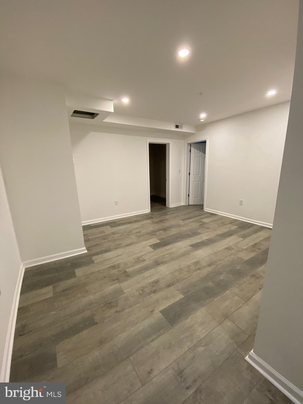 45 East High Street, Unit 2ND & 3 Pottstown, PA 19464 - Photo 25 of 34 an empty room with wooden floor and windows