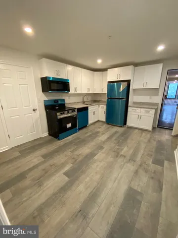a kitchen with stainless steel appliances a refrigerator and a microwave