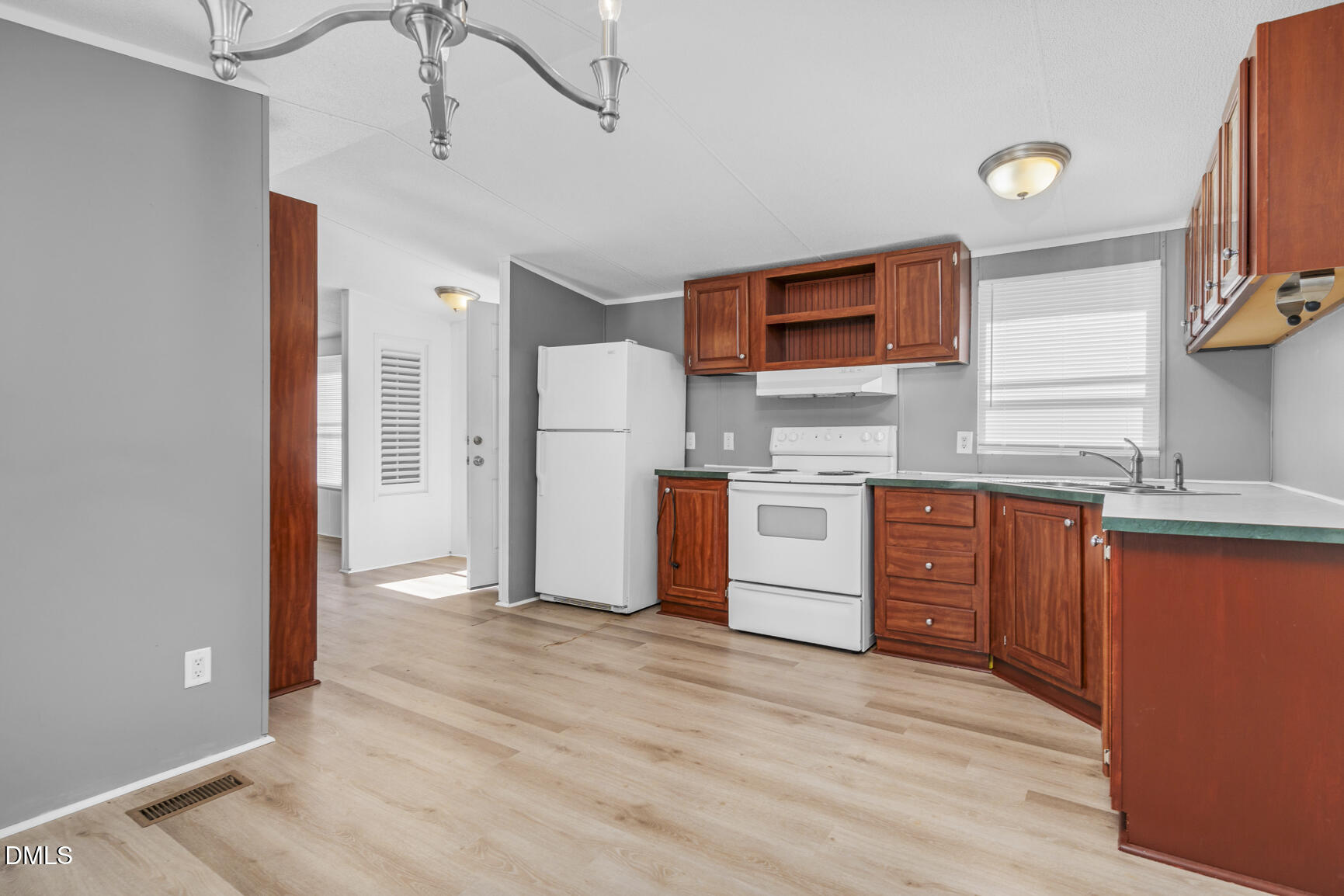 6515 Tonya Road Elm City, NC 27822 - Photo 36 of 52 a kitchen with stainless steel appliances granite countertop a refrigerator a sink dishwasher and a stove with wooden floor