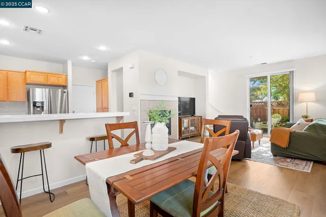 a living room with furniture a fireplace and a large window