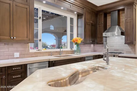 a view of a backyard of a house with table and chairs