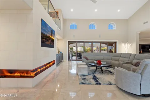 a living room with furniture a rug and kitchen view