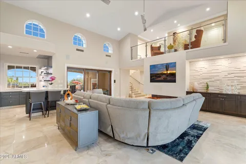 a bedroom with a large bed and wooden floor