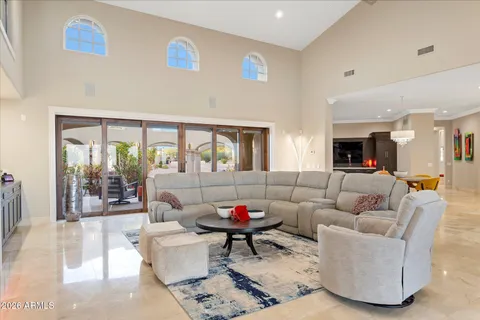 a spacious bedroom with a bed and a flat screen tv