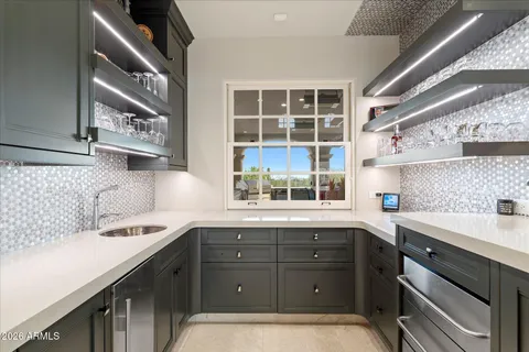 a large bathroom with a large mirror vanity sink and a large mirror