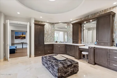 a view of a dining room with furniture a rug and wooden floor