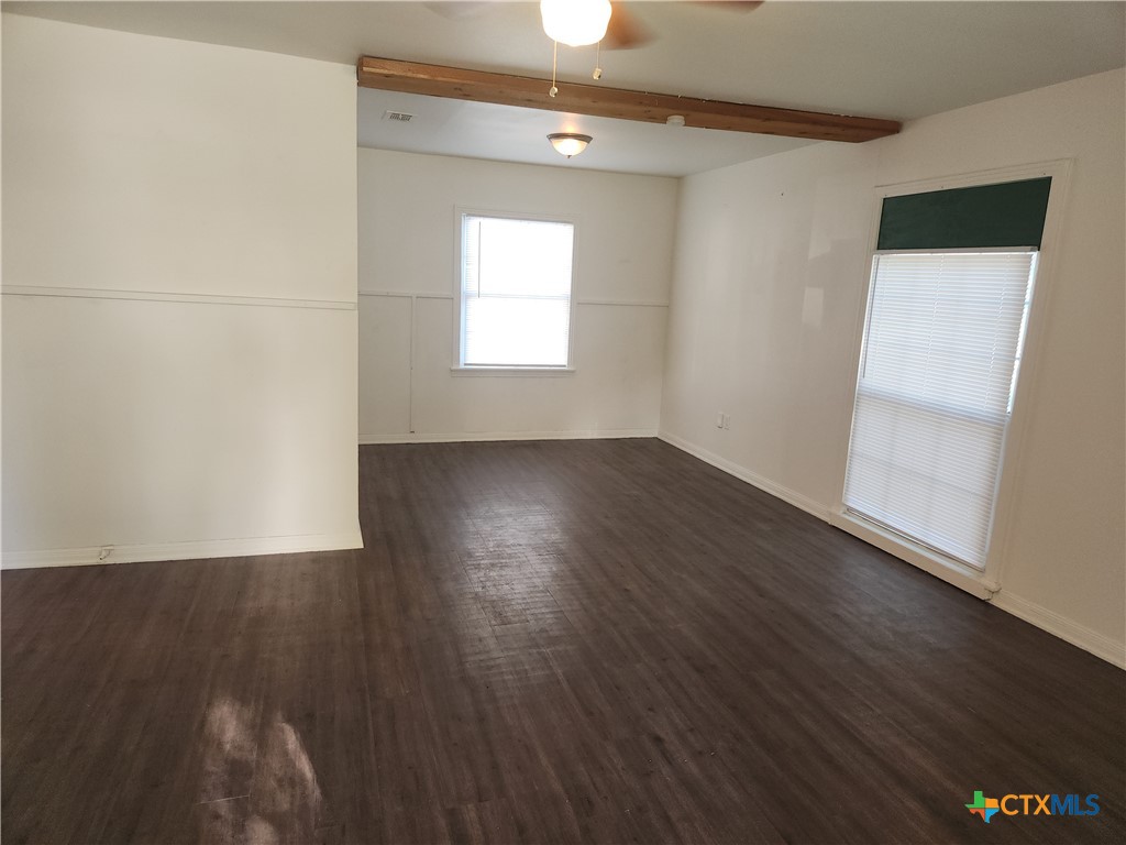 902 South 23rd Street Temple, TX 76504 - Photo 2 of 8 an empty room with wooden floor and windows