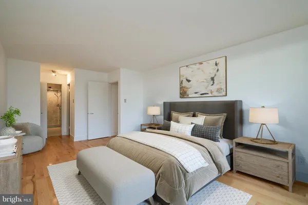 a bedroom with a bed and wooden floor