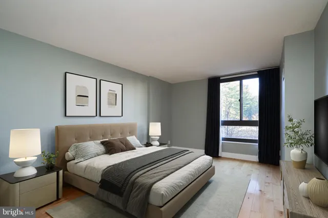 a bedroom with a bed and a large window