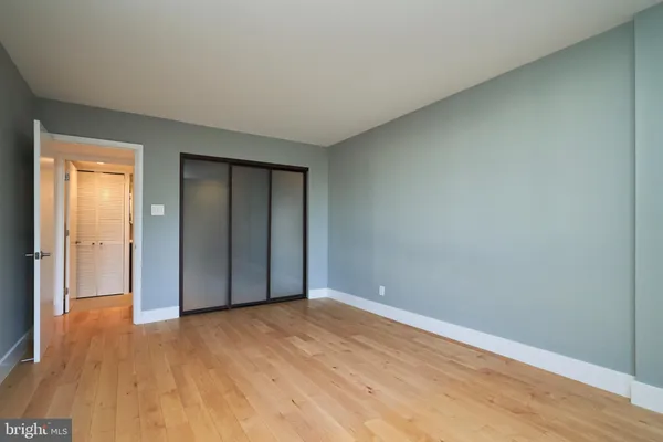 a view of an empty room and wooden floor