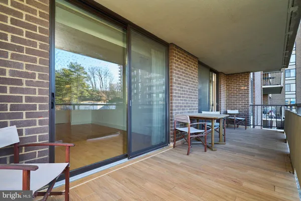 a view of a livingroom with chairs and table in patio