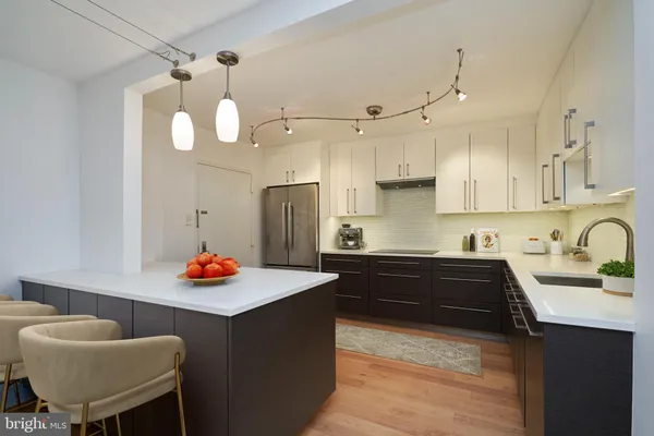 a kitchen with stainless steel appliances granite countertop a sink a stove and a refrigerator