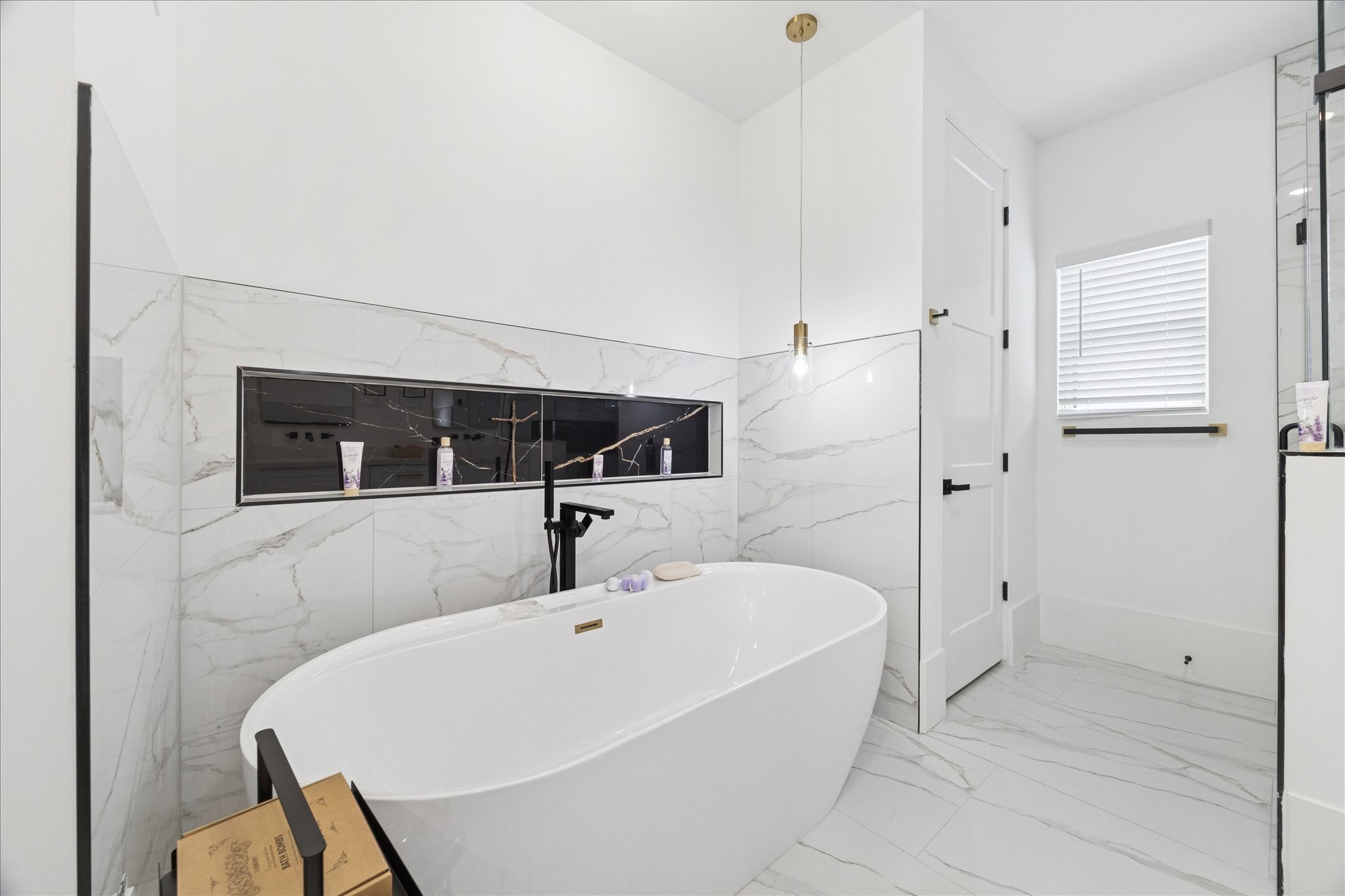 9233 Madera Road Houston, TX 77078 - Photo 16 of 25 a bathroom with a bathtub and a shower