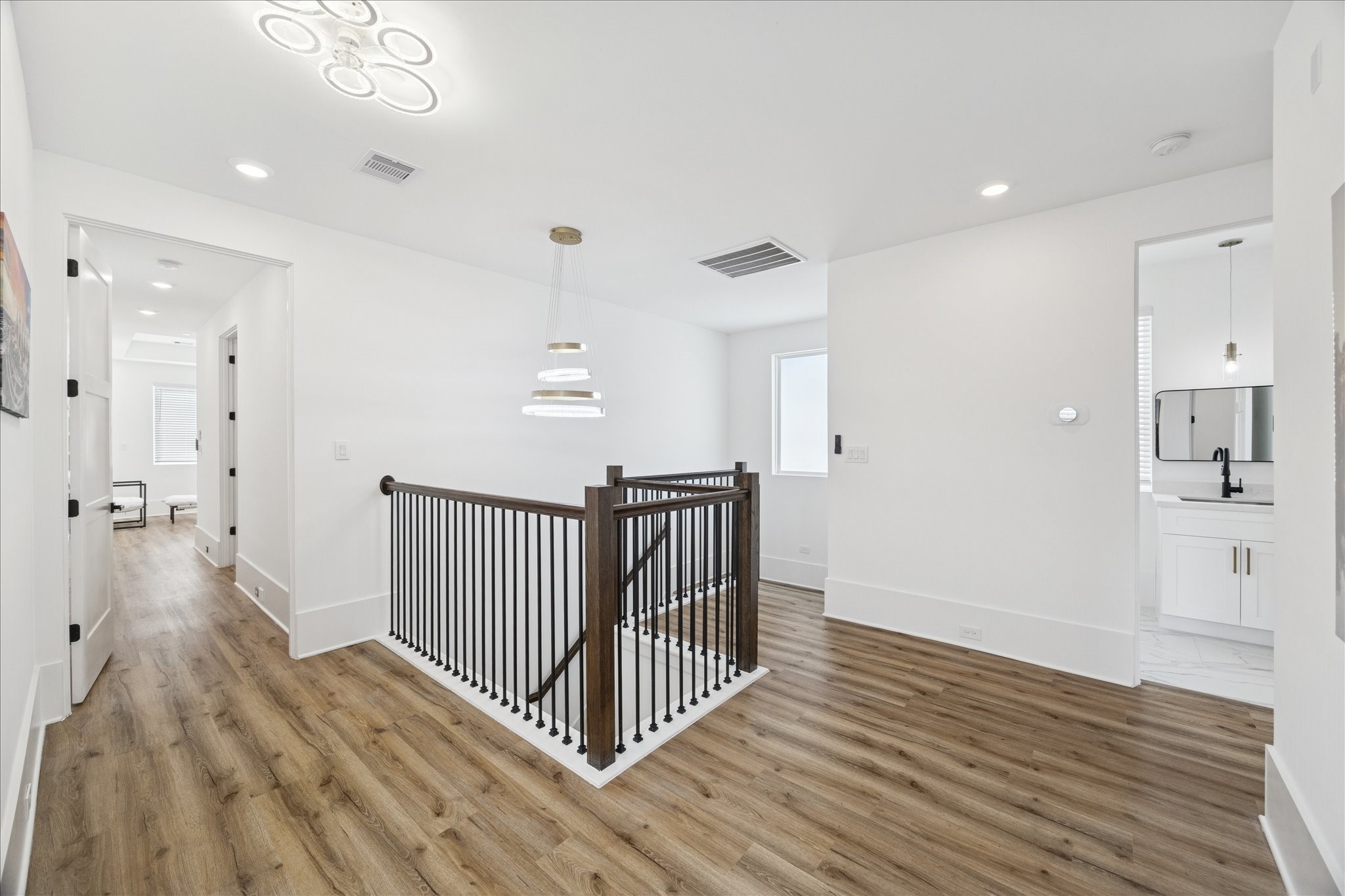 9233 Madera Road Houston, TX 77078 - Photo 17 of 25 a view of a hallway with wooden floor and staircase