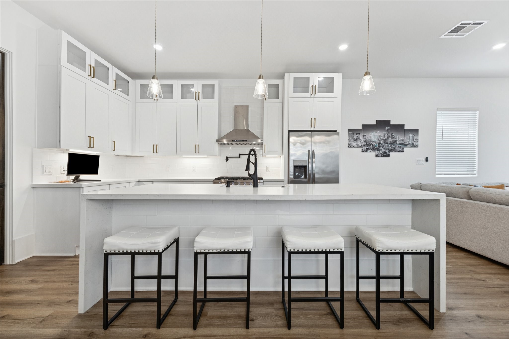 9233 Madera Road Houston, TX 77078 - Photo 3 of 25 a kitchen with stainless steel appliances granite countertop a table chairs in it and wooden floors