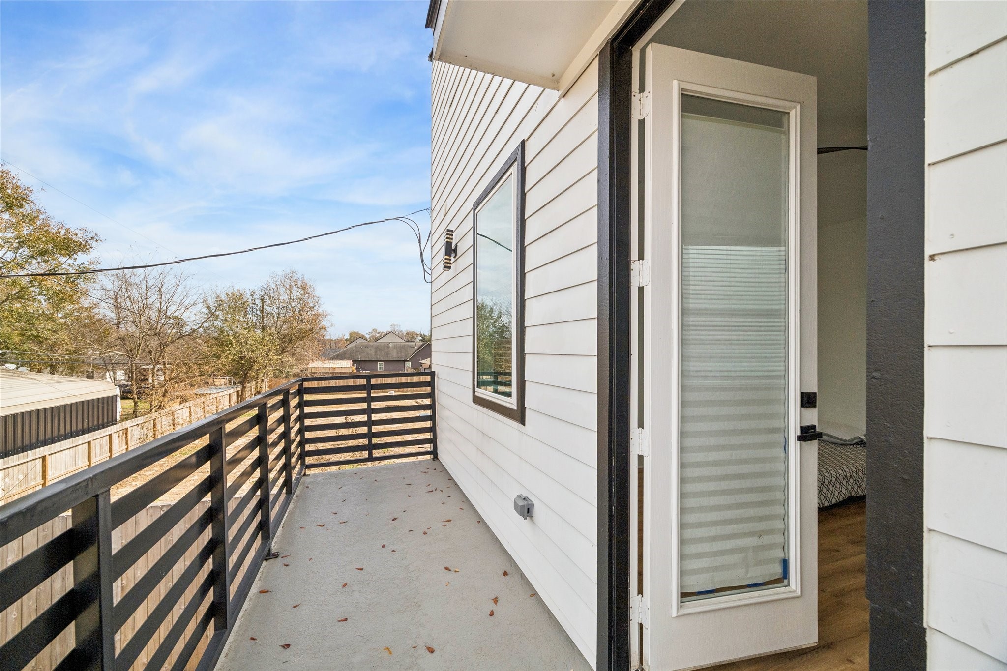 9233 Madera Road Houston, TX 77078 - Photo 5 of 25 a view of a balcony with wooden floor and iron stairs