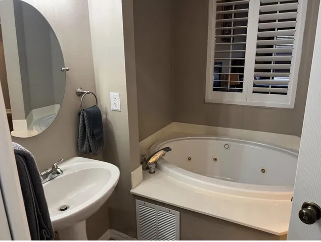 a kitchen with white cabinets and a sink