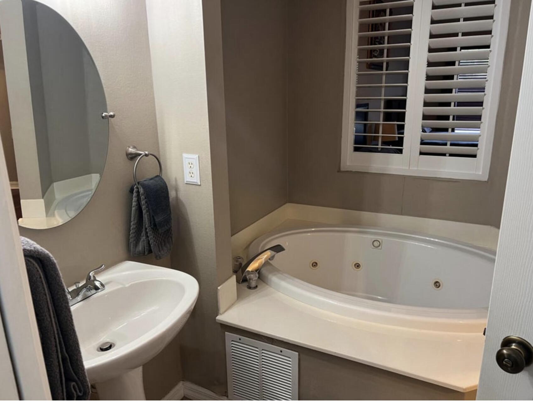 9871 Perfect Drive, Unit 144 Port St. Lucie, FL 34986 - Photo 4 of 11 a bathroom with a sink and a mirror