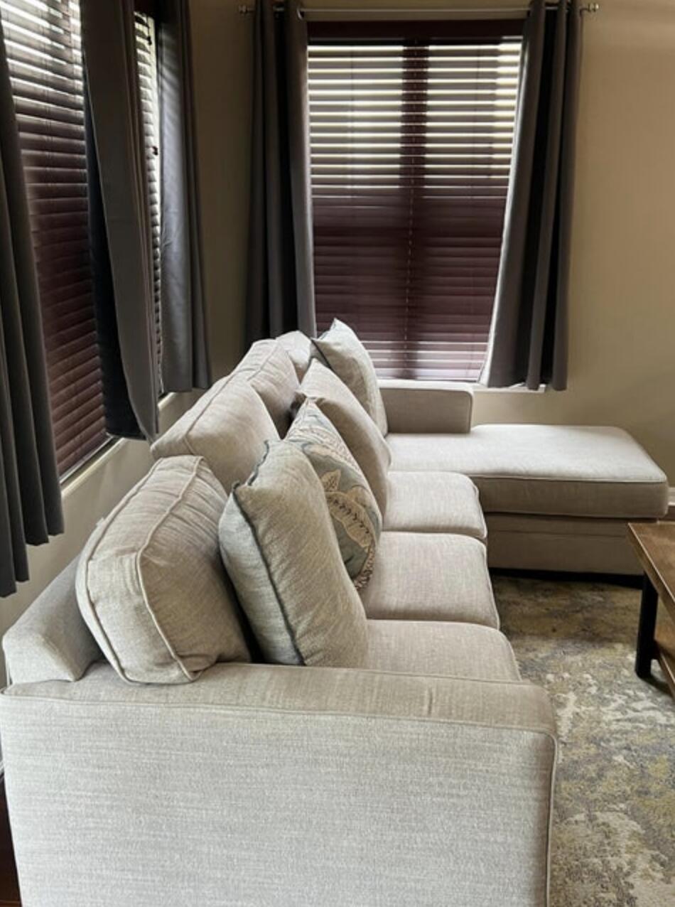 9871 Perfect Drive, Unit 144 Port St. Lucie, FL 34986 - Photo 8 of 11 a living room with furniture and a window