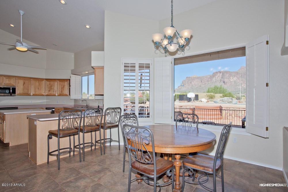 365 North Muleshoe Road Apache Junction, AZ 85119 - Photo 20 of 54 a view of a dining room with furniture a chandelier and wooden floor
