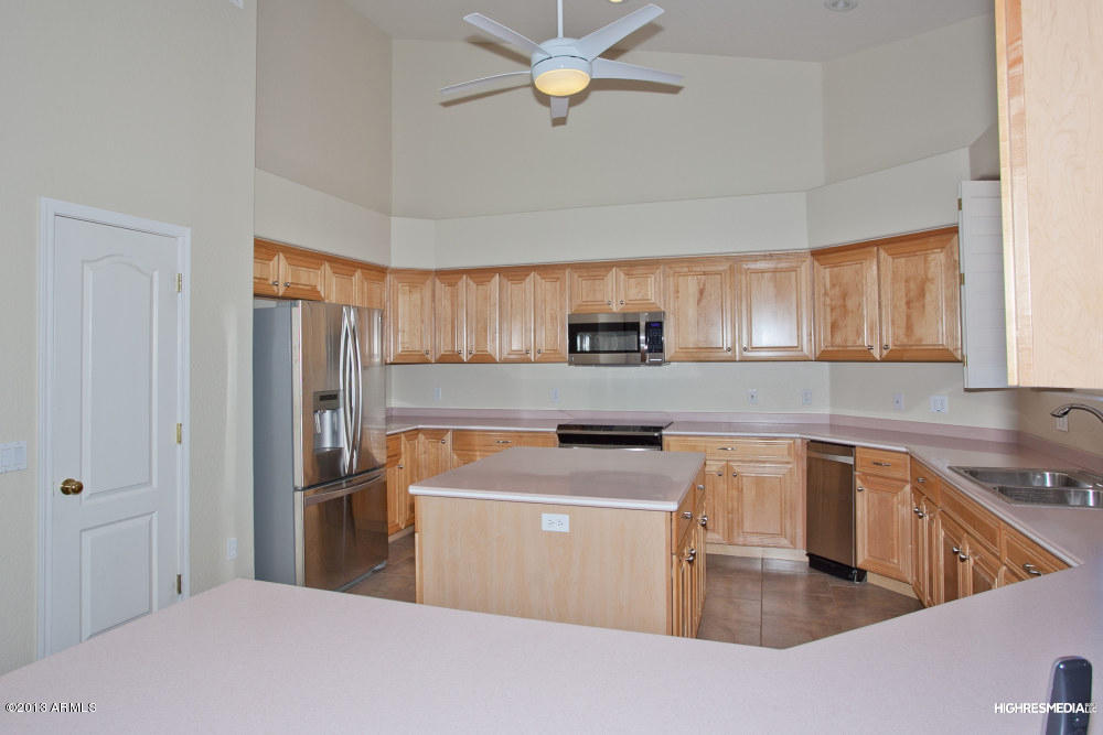 365 North Muleshoe Road Apache Junction, AZ 85119 - Photo 27 of 54 a kitchen with stainless steel appliances a stove a sink a refrigerator a center island cabinets and furniture