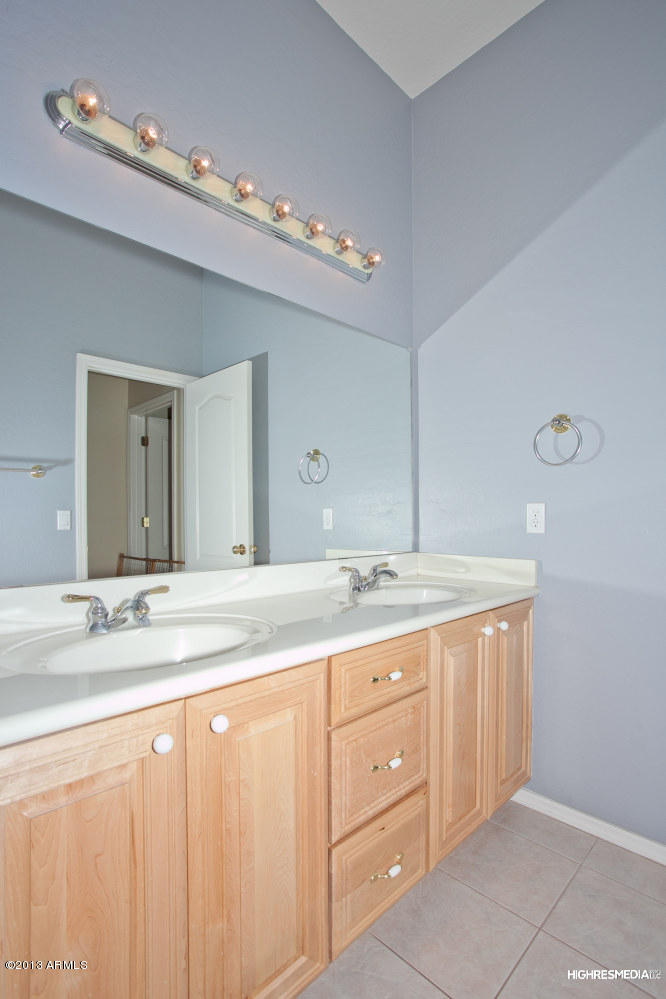 365 North Muleshoe Road Apache Junction, AZ 85119 - Photo 33 of 54 a bathroom with a granite countertop sink and a mirror