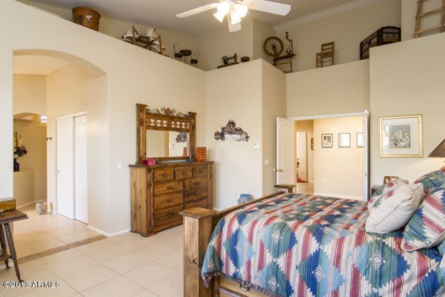 365 North Muleshoe Road Apache Junction, AZ 85119 - Photo 36 of 54 a bedroom with a bed and dresser with mirror