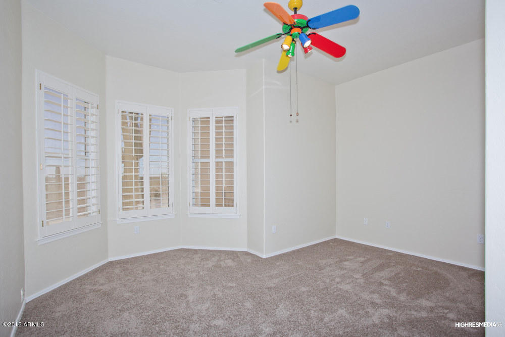 365 North Muleshoe Road Apache Junction, AZ 85119 - Photo 46 of 54 a view of an empty room with window and chandelier fan