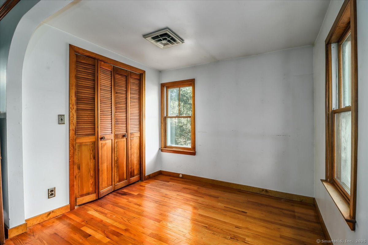 16 Farrell Road Newtown, CT 06470 - Photo 12 of 38 a view of empty room with window and wooden floor