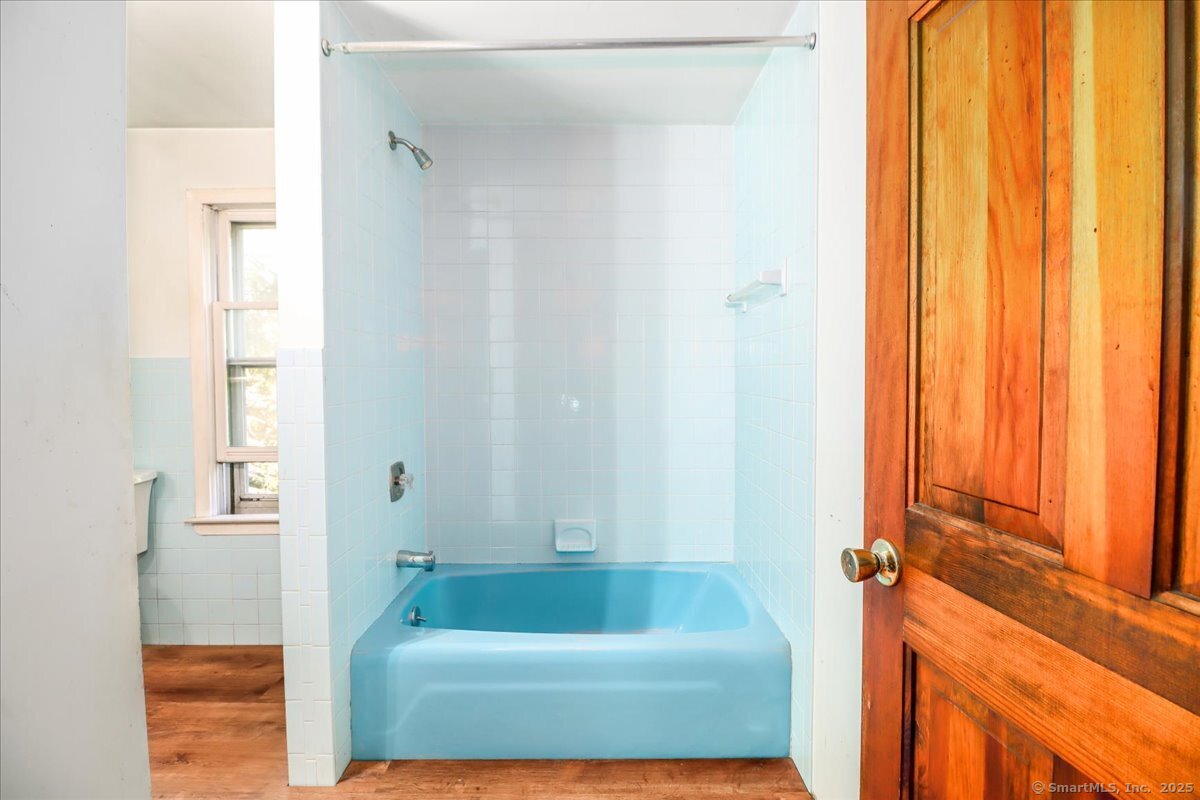 16 Farrell Road Newtown, CT 06470 - Photo 16 of 38 a bathroom with a tub and shower