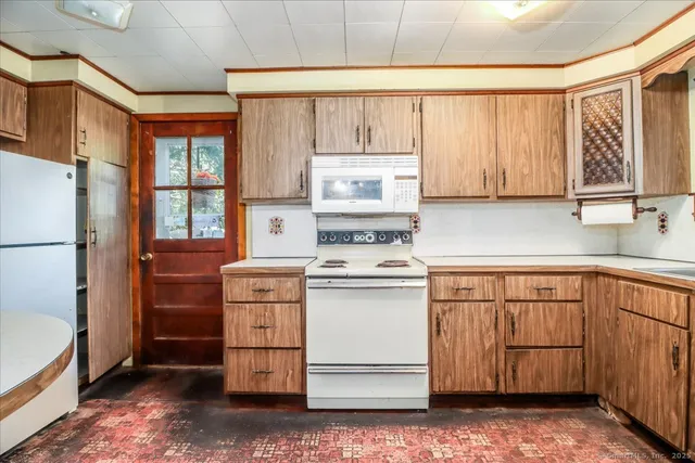 a kitchen with granite countertop cabinets stainless steel appliances a sink and window