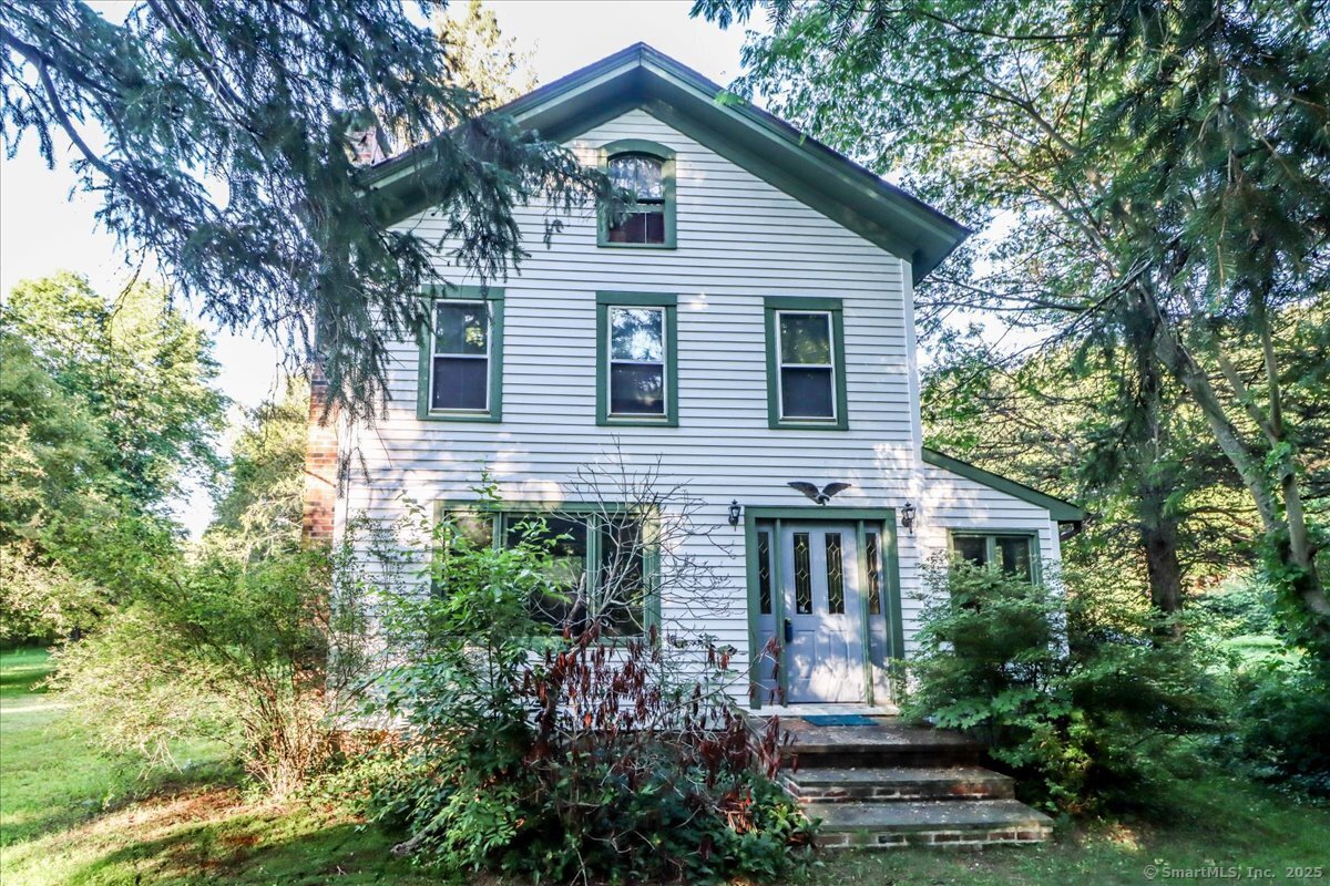 16 Farrell Road Newtown, CT 06470 - Photo 19 of 38 a front view of a house with plants and garden