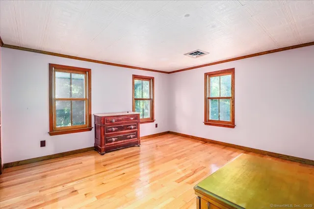 an empty room with furniture and windows