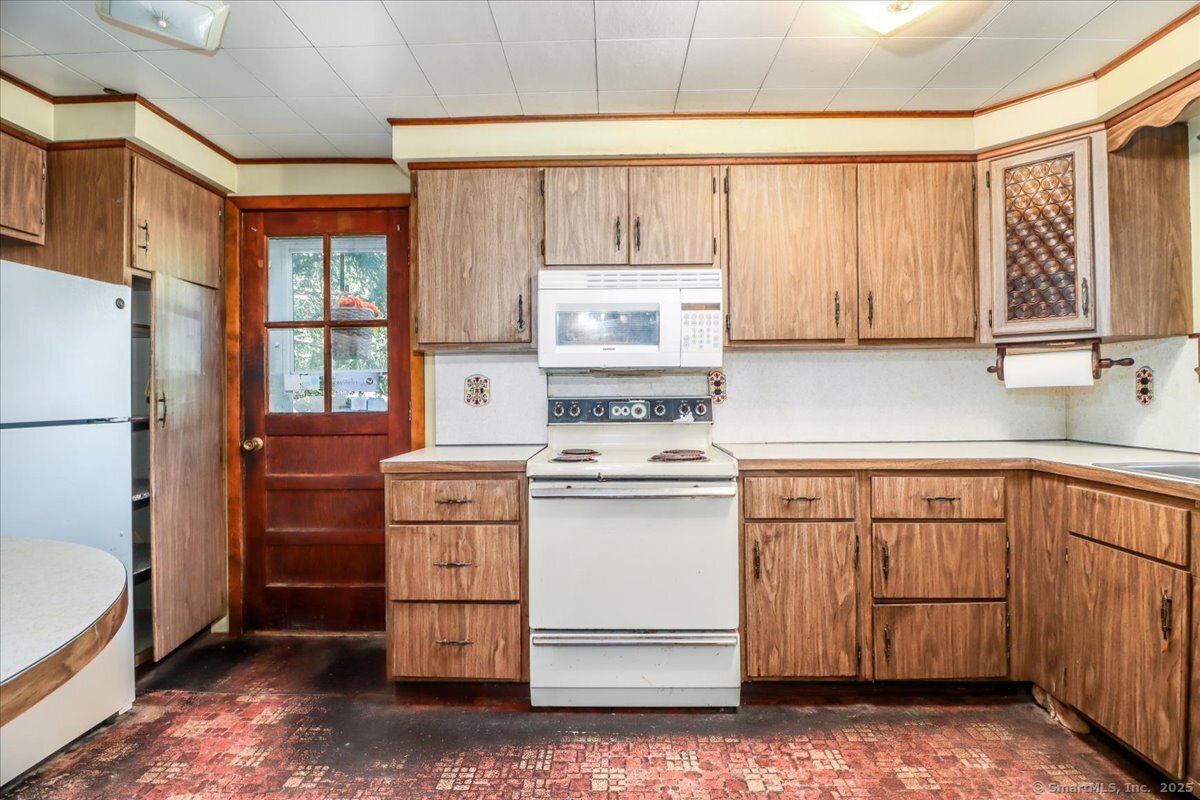 16 Farrell Road Newtown, CT 06470 - Photo 30 of 38 a kitchen with a stove a sink and a refrigerator