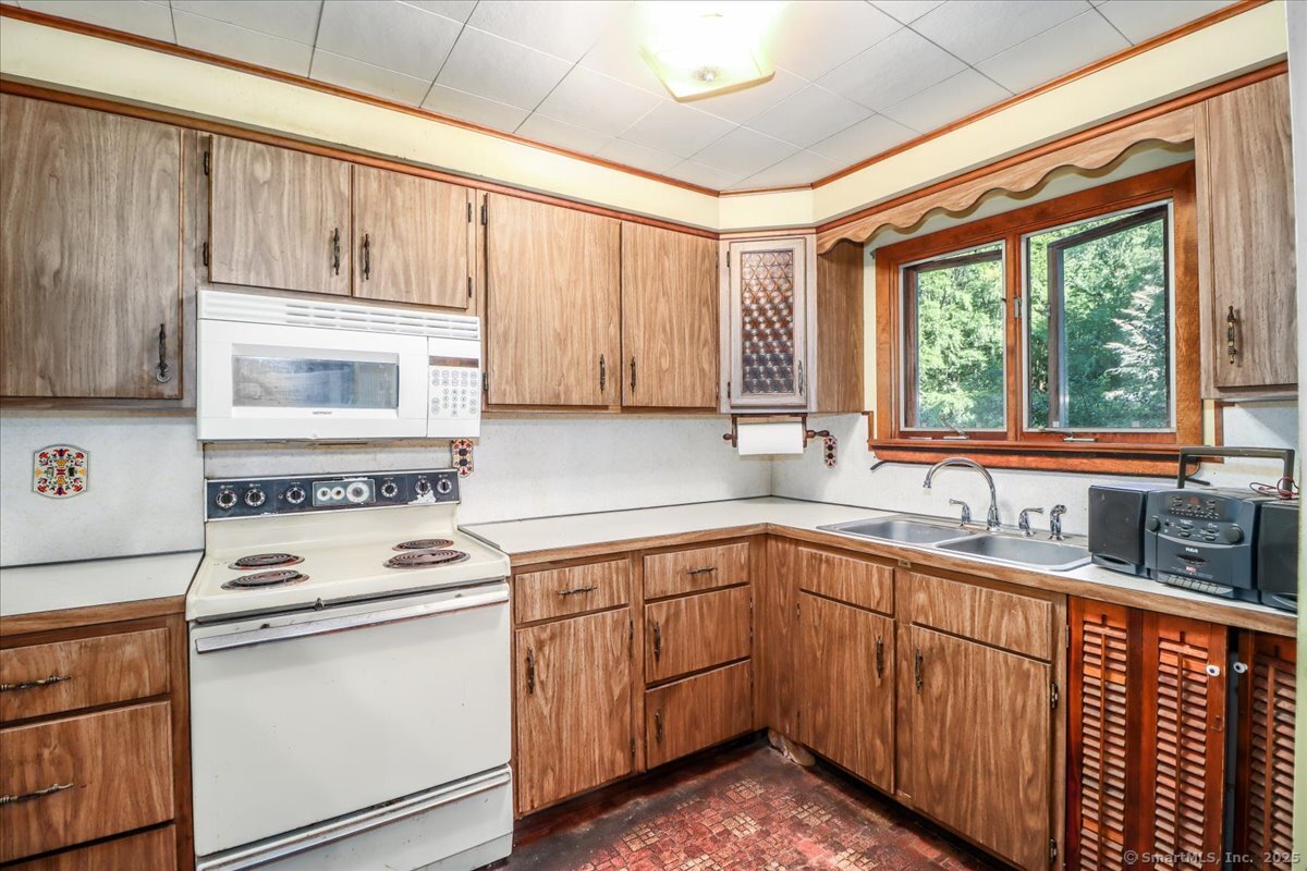 16 Farrell Road Newtown, CT 06470 - Photo 31 of 38 a kitchen with granite countertop cabinets stainless steel appliances a sink and window