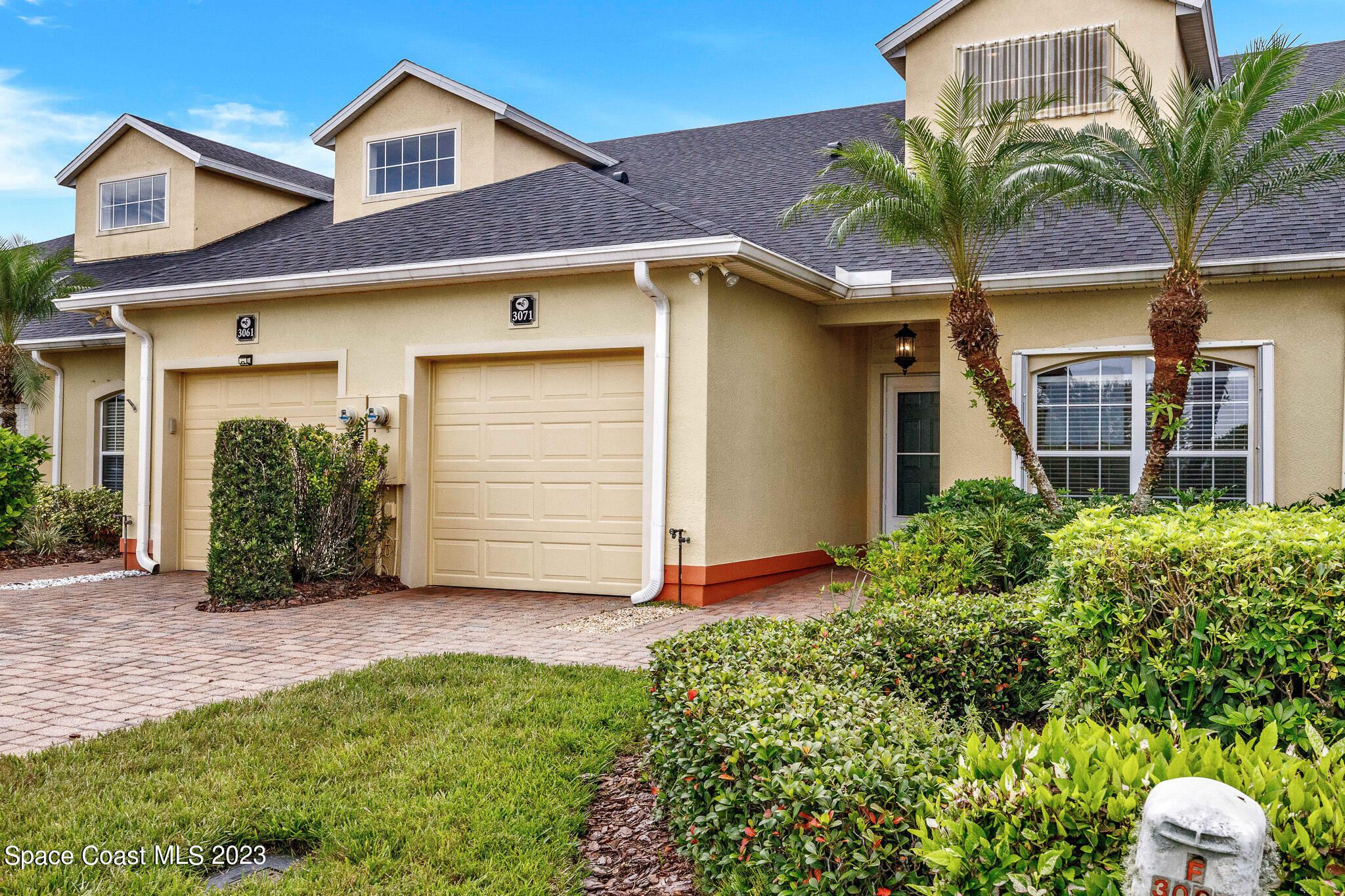 3071 Le Conte Street Melbourne, FL 32940 - Photo 19 of 41 a front view of a house with a yard and garage