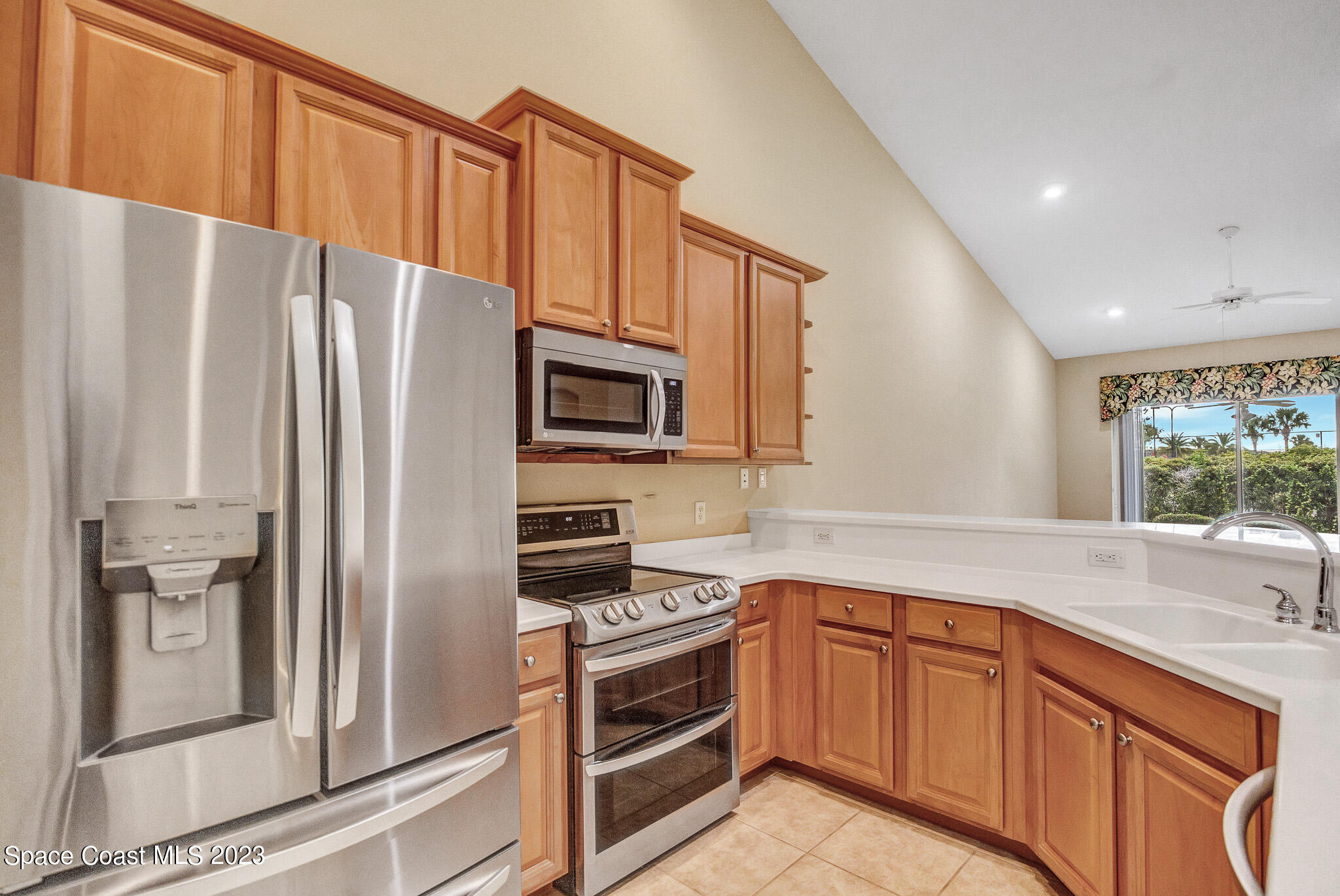 3071 Le Conte Street Melbourne, FL 32940 - Photo 2 of 41 a kitchen with stainless steel appliances a refrigerator sink and microwave