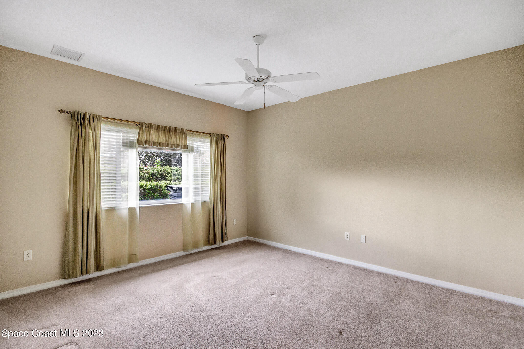 3071 Le Conte Street Melbourne, FL 32940 - Photo 6 of 41 an empty room with a window and a ceiling fan
