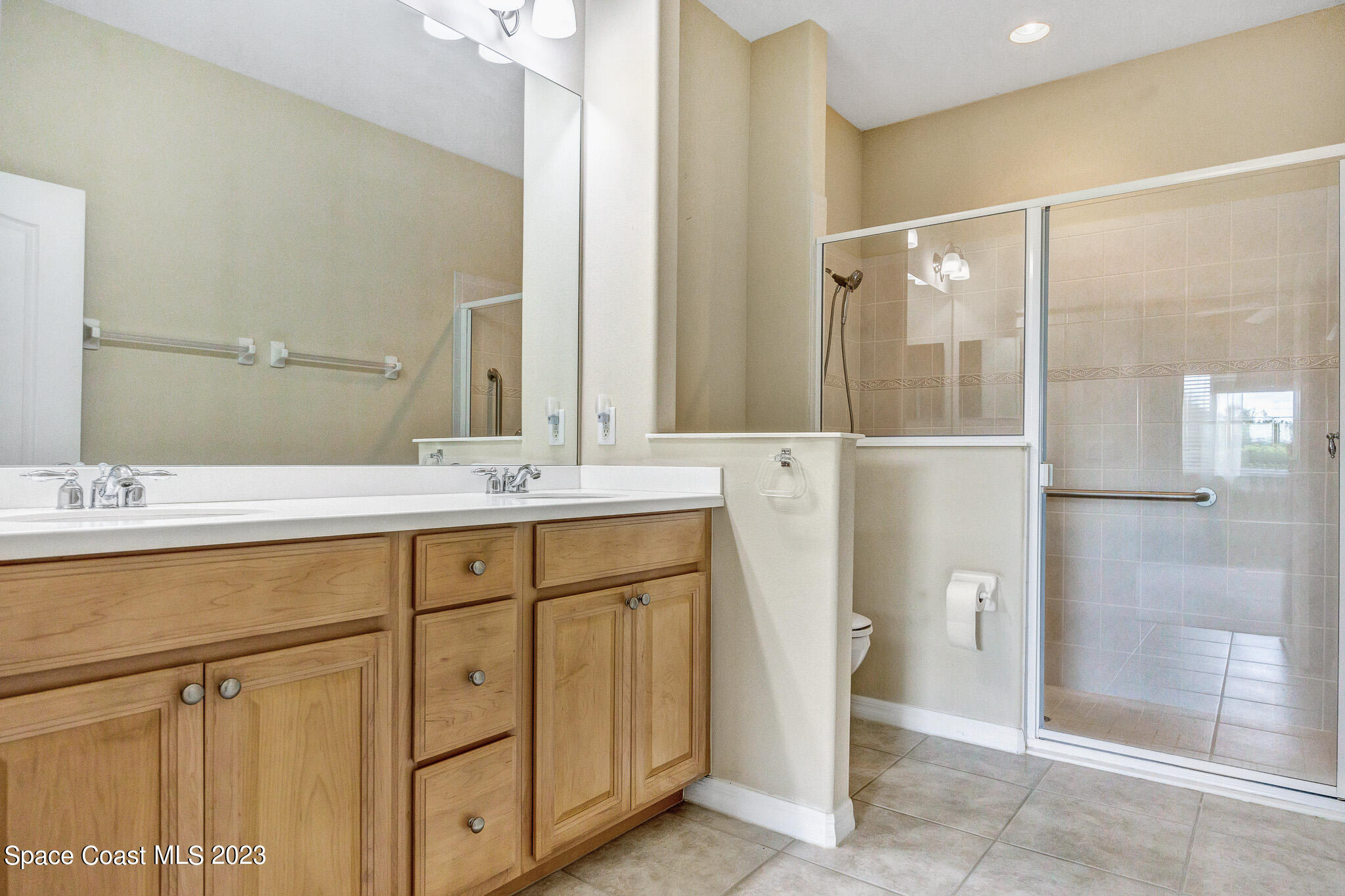 3071 Le Conte Street Melbourne, FL 32940 - Photo 7 of 41 a bathroom with a shower sink and mirror