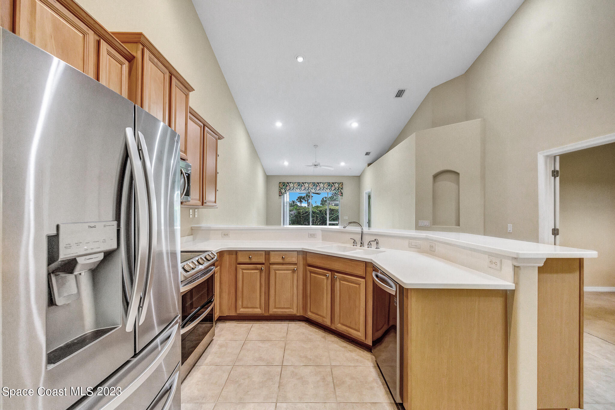 3071 Le Conte Street Melbourne, FL 32940 - Photo 9 of 41 a kitchen with stainless steel appliances granite countertop a sink and dishwasher a refrigerator with wooden floor