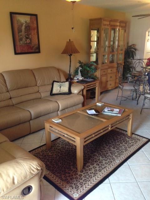 4338 27th Court Southwest, Unit 8201 Naples, FL 34116 - Photo 11 of 19 a living room with furniture and wooden floor