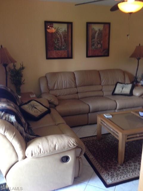 4338 27th Court Southwest, Unit 8201 Naples, FL 34116 - Photo 12 of 19 a living room with furniture and a couch