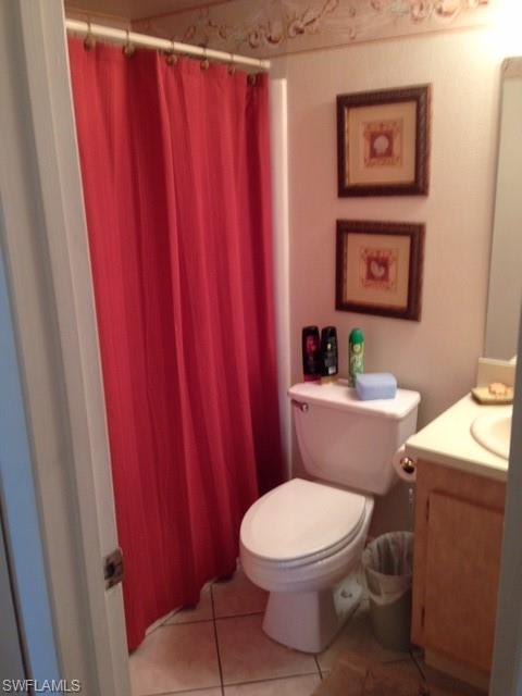 4338 27th Court Southwest, Unit 8201 Naples, FL 34116 - Photo 4 of 19 a white toilet sitting next to a shower curtain