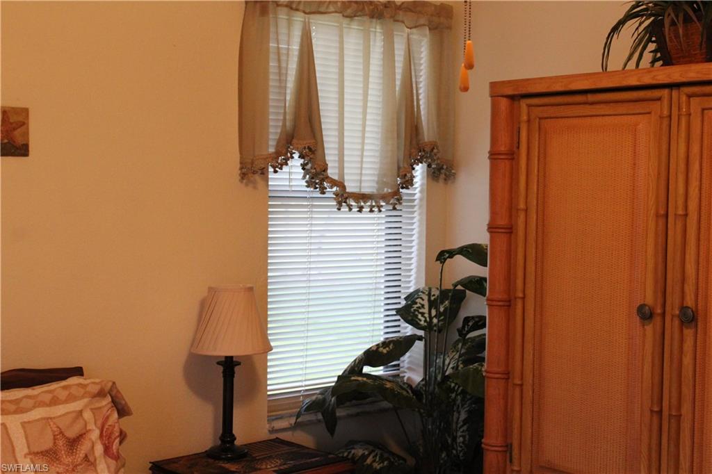 4338 27th Court Southwest, Unit 8201 Naples, FL 34116 - Photo 8 of 19 a view of hallway with chair and a window